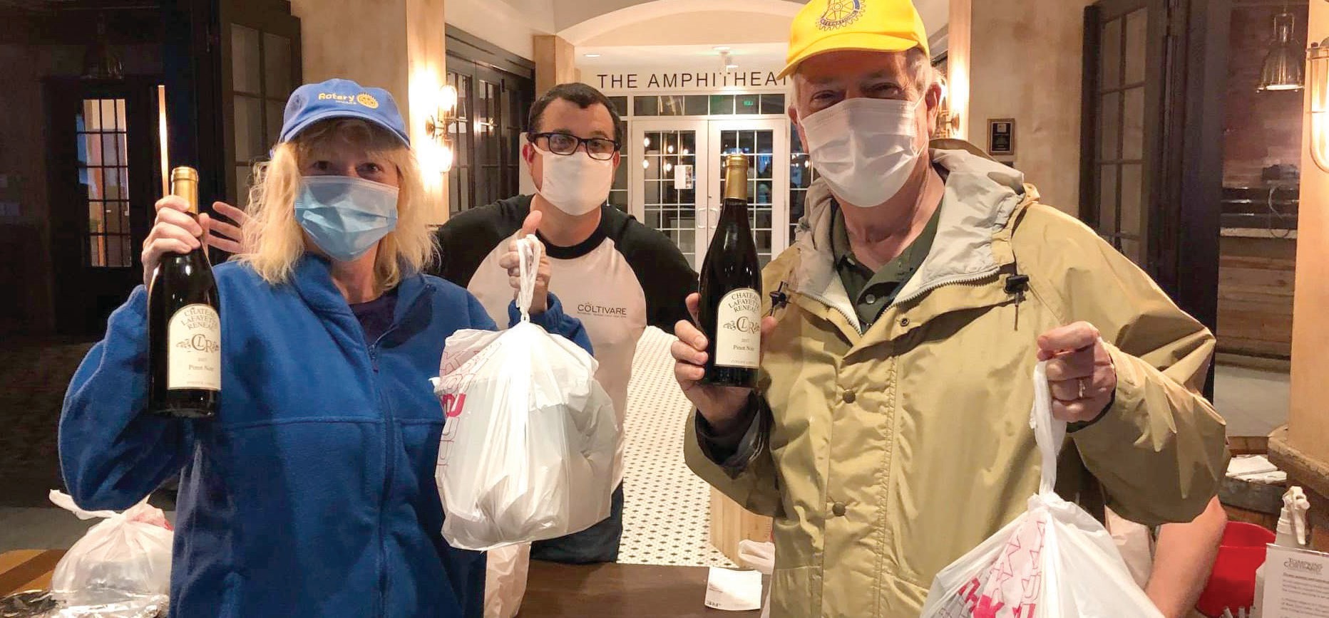 Ithaca Rotarians Ivy Stevens-Gupta (left) and Jeff True (right) pick up dinner from Coltivare’s Jason Sidle (middle) as part of Ithaca Rotary’s new Tastes of Gorges program. Photo provided