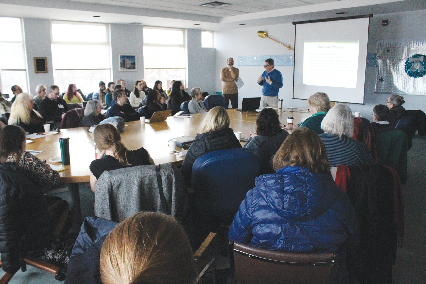 Rich Bennett and Roy Murdough present to local service providers at the Homeless and Housing Taskforce. Murdough is the new program director for the emergency shelter on State Street that will now be run by St. John's Community Services after Tompkins County decided not to renew its contract with the Rescue Mission.