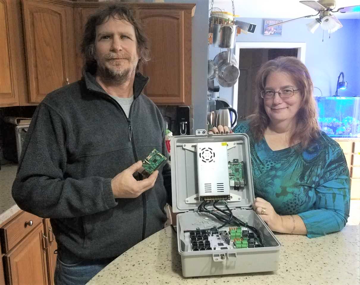 John Scott (left) and Beth Underwood Scott (right), showing the Falcon pixel control board John uses to program everything with.