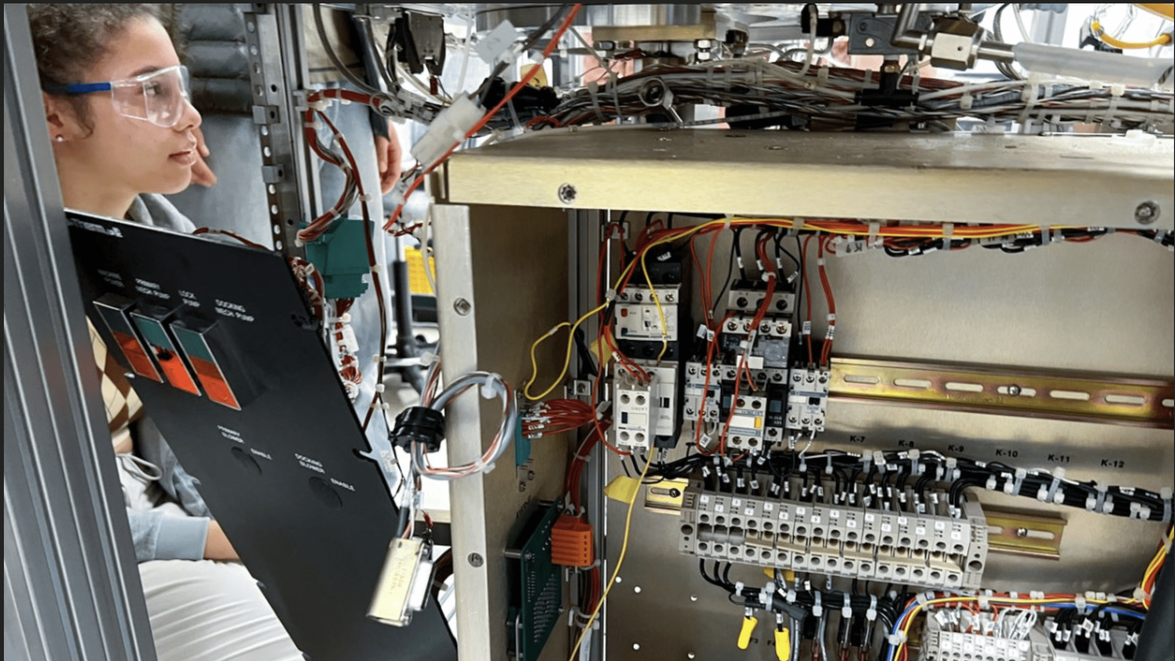 New Visions Engineering student Marley Thomson disassembles a plasma etcher.