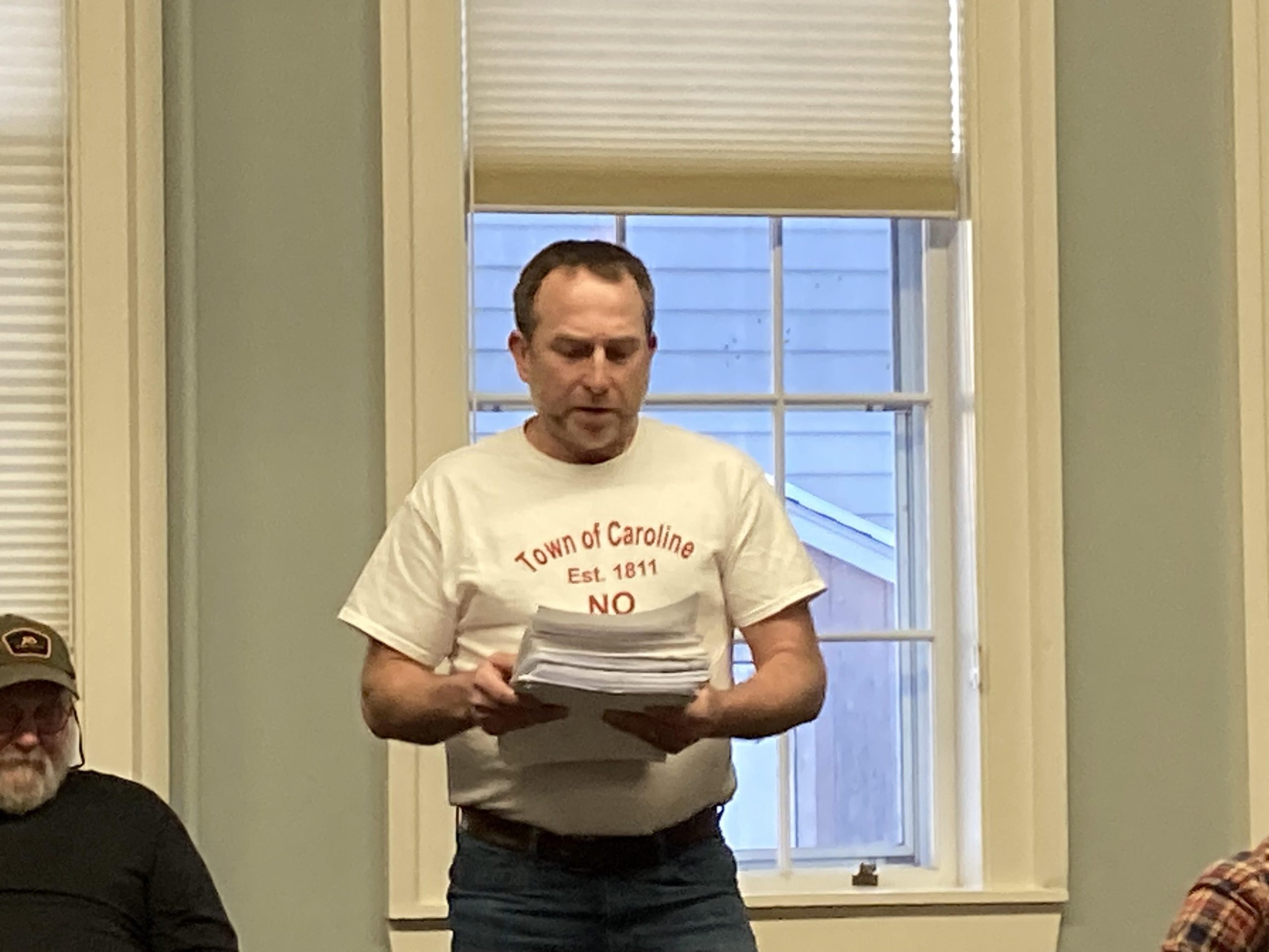 a Caroline resident reads the petition at a town meeting