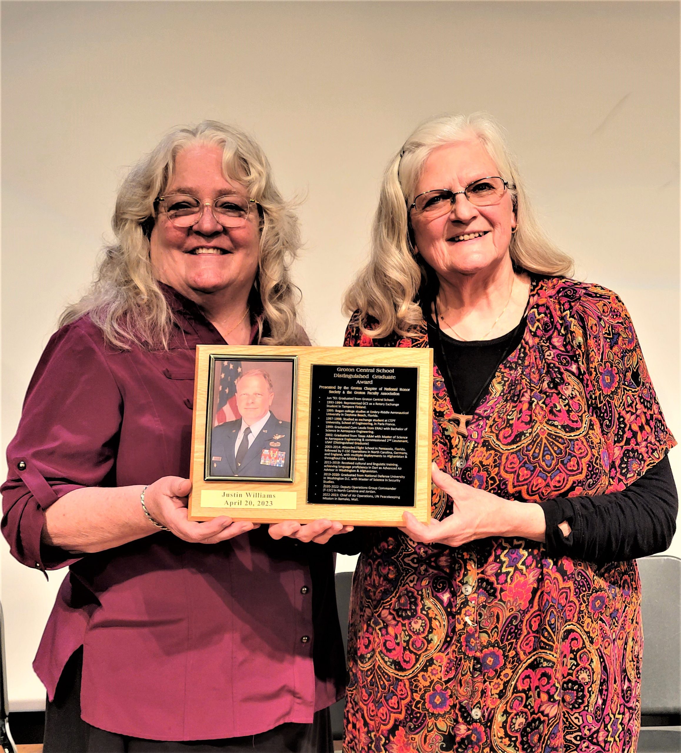 Barbara Lonsky (left) and Dolores Williams hold the plaque honoring Williams' son, Colonel Justin Williams, United States Air Force, who was inducted into the Groton High School Distinguished Graduate Hall of Fame at its annual ceremony on April 20.