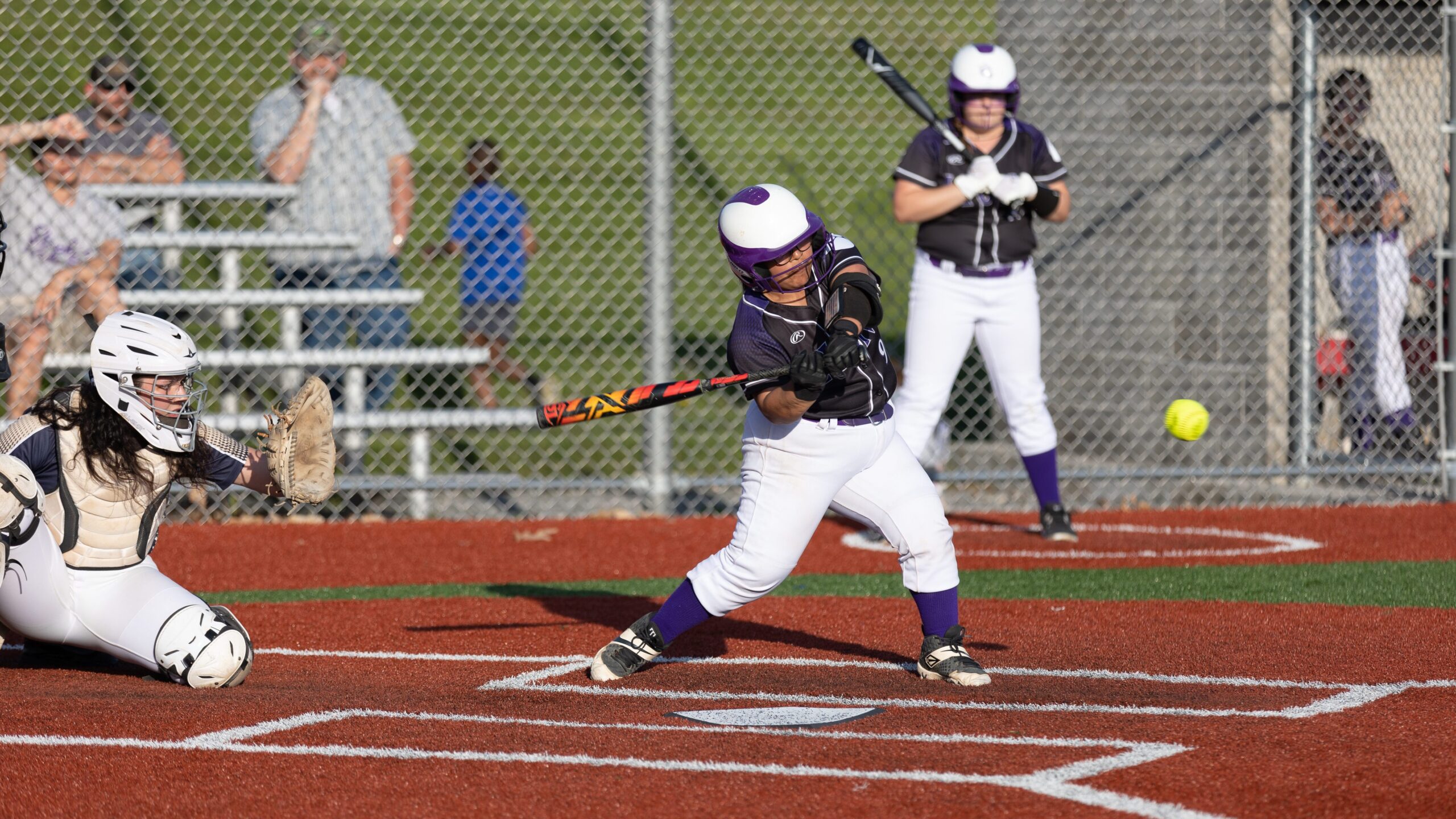 Dryden softball's Olivia Surine swings at a pitch during the IAC Large School Championship on May 11. The junior has been a reliable force behind the plate, helping the Lions with their first IAC divisional title since 1988. 
