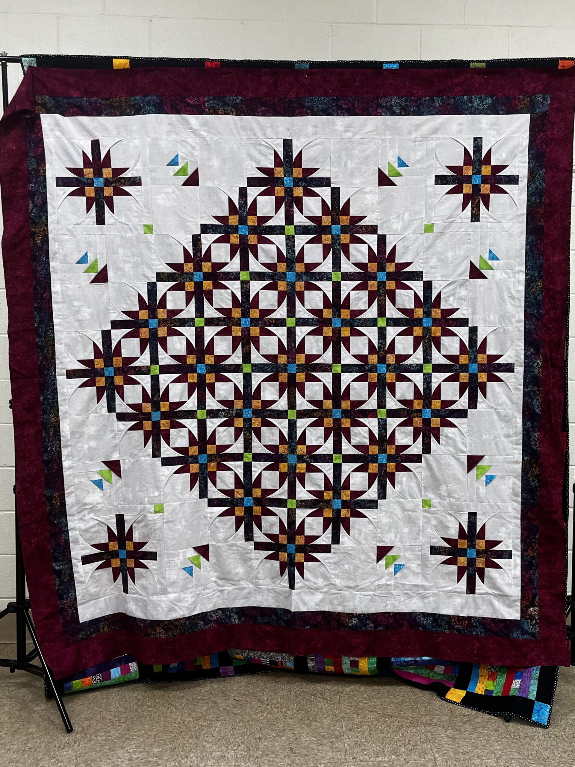 a multi colored quilt on display