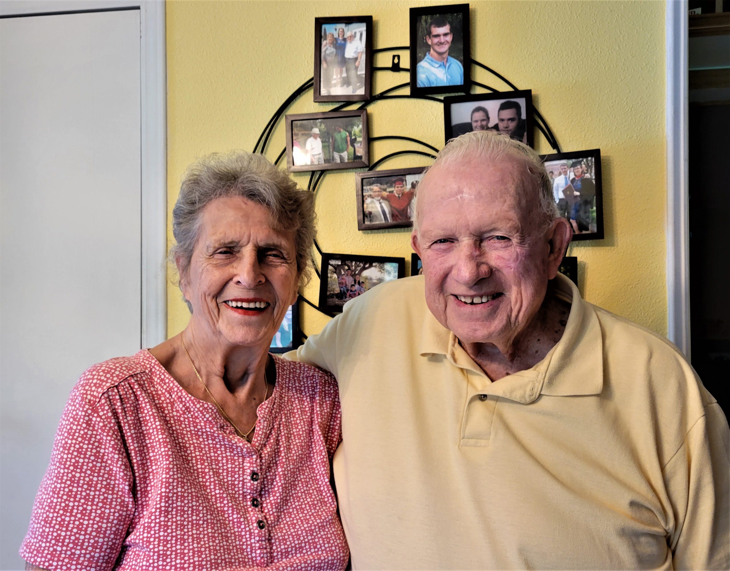 Arlene (left) and Jerry Caward Sr. in their home on Atwater Road, Lansing with a background of just a few of the many family photos proudly displayed there. The Cawards will celebrate their 70th anniversary on June 26.