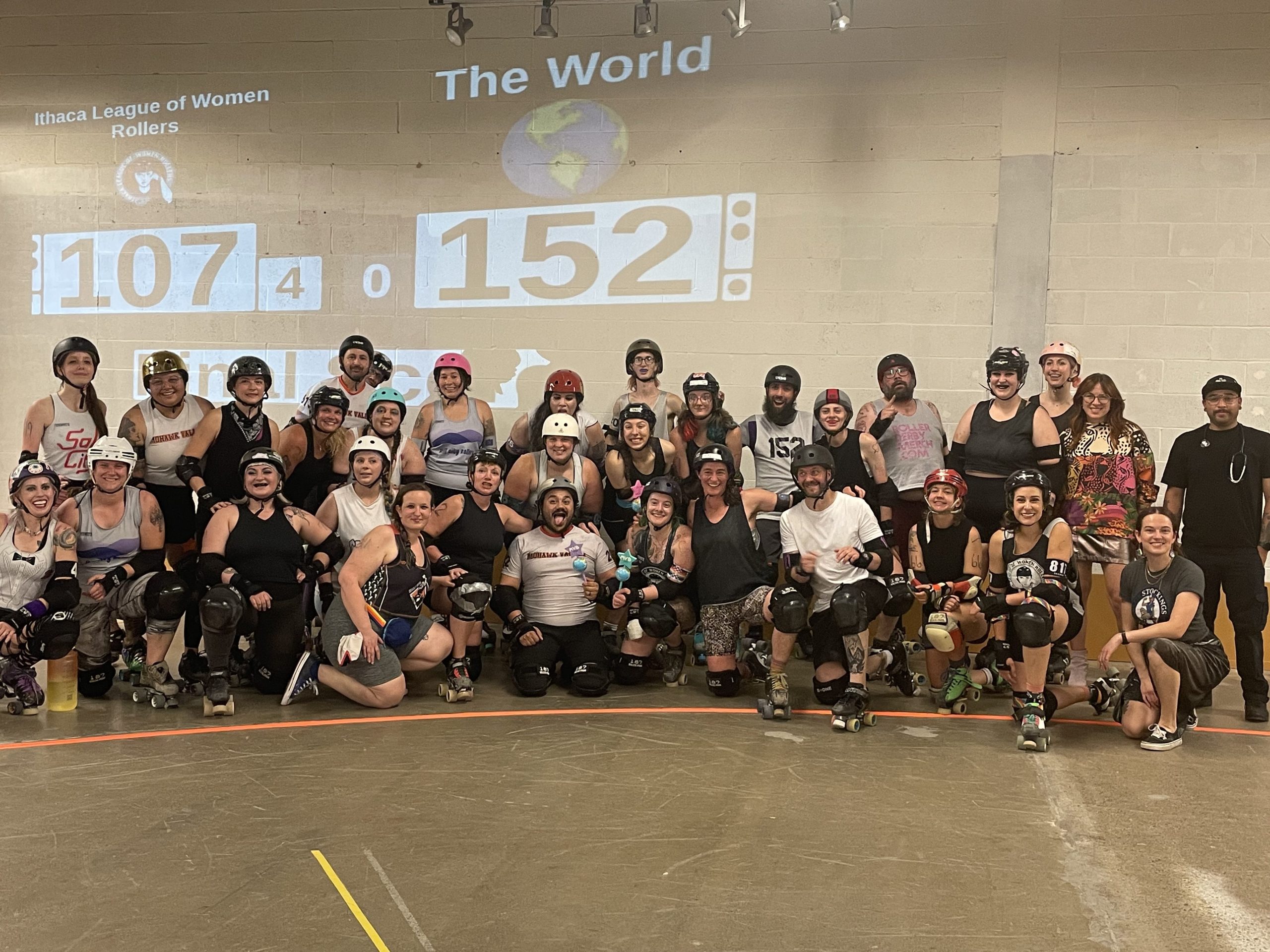Members from "Team Ithaca" and "Team World" pose together following the advanced bout of the Ithaca Roller Derby's "Ithaca vs. The World" doubleheader scrimmage on June 17 at The Shops at Ithaca Mall.