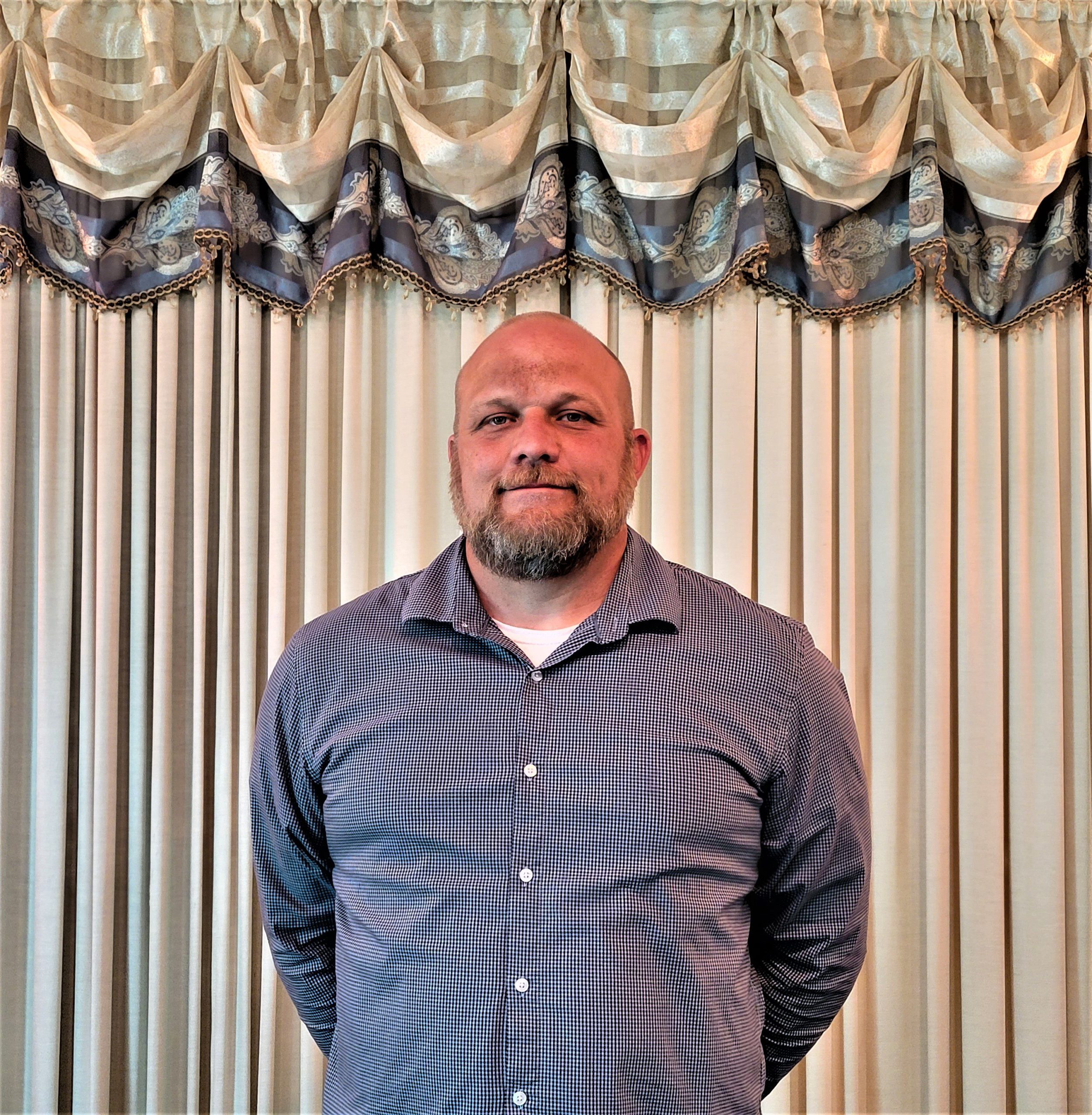 Man in front of curtains
