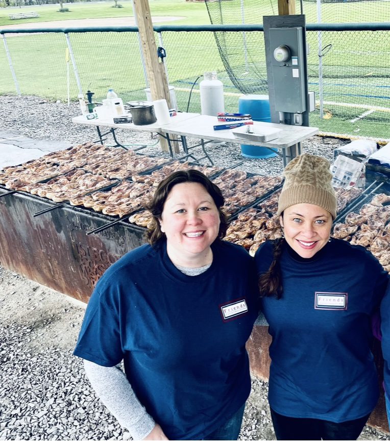 Chair of the Friends of the Lansing Community Library Megan Williams (left) and Amalia Gonzalez at the annual chicken bbq fundraiser. 