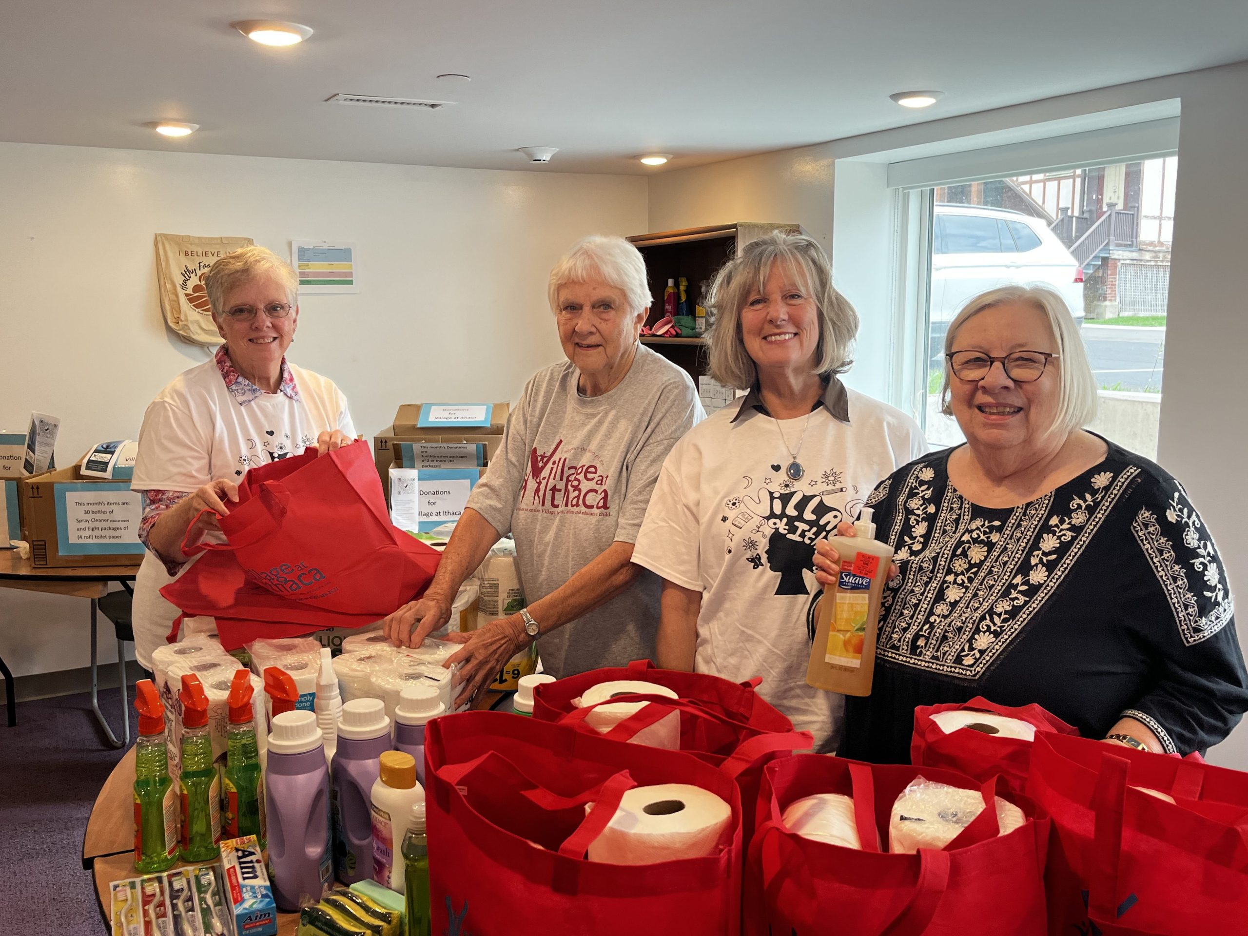 Jami Breedlove-Crouch, Judy Jones, Mary Clabby, and Shella Chace lead their respective churches’ donation and volunteer efforts with The Village at Ithaca. Here, they are packing household bags for different families across the Ithaca area.