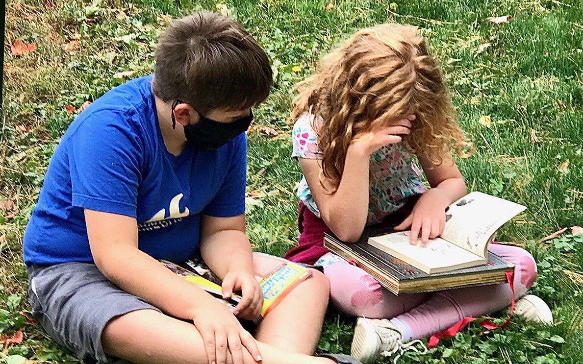 Rosen Fund grants provide primarily small and rural libraries with important childhood literacy services like story times, ‘tween and teen book clubs, summer reading programs and more. These children are reading at a book sale in Ulysses. Photo provided