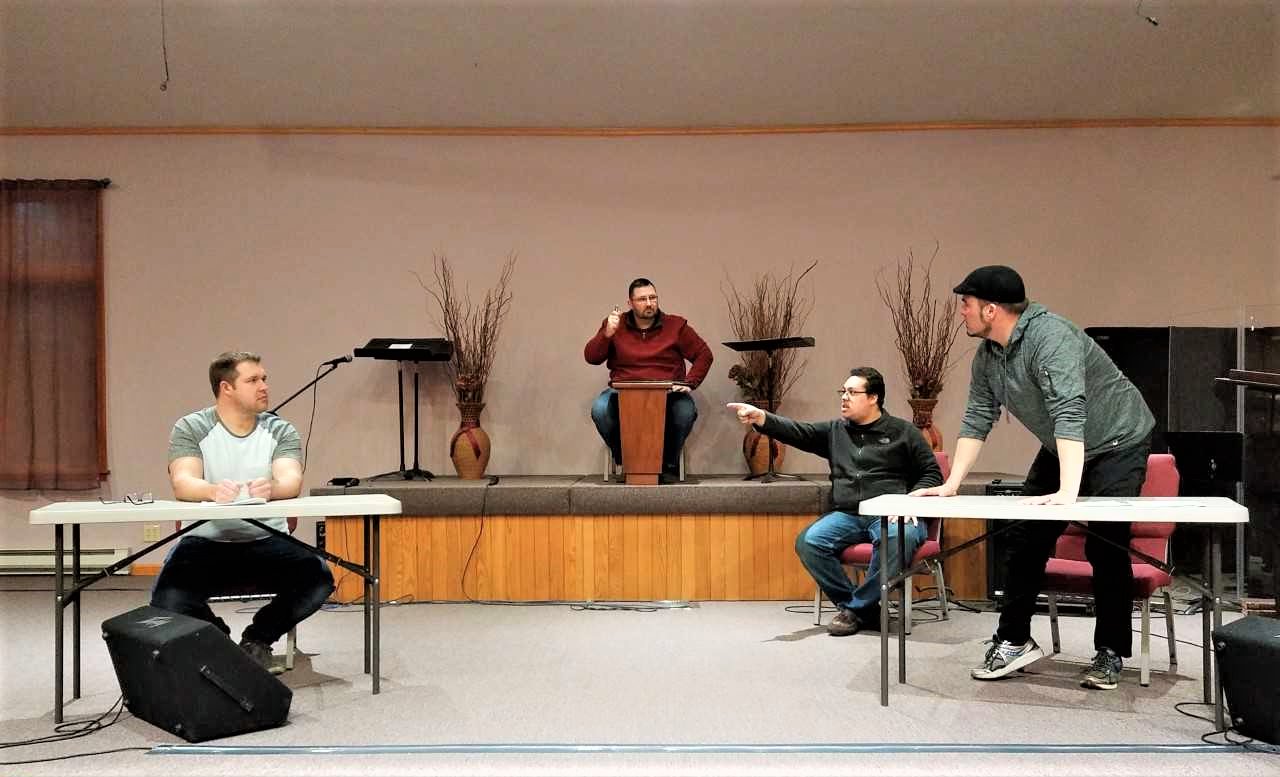 The cast of Groton Assembly of God’s Easter drama, “Guilty as Charged” during one of their rehearsals. Left to right: Joe Wright, Tony Lanzilotta, Elias Rivera, Justin Besler.
