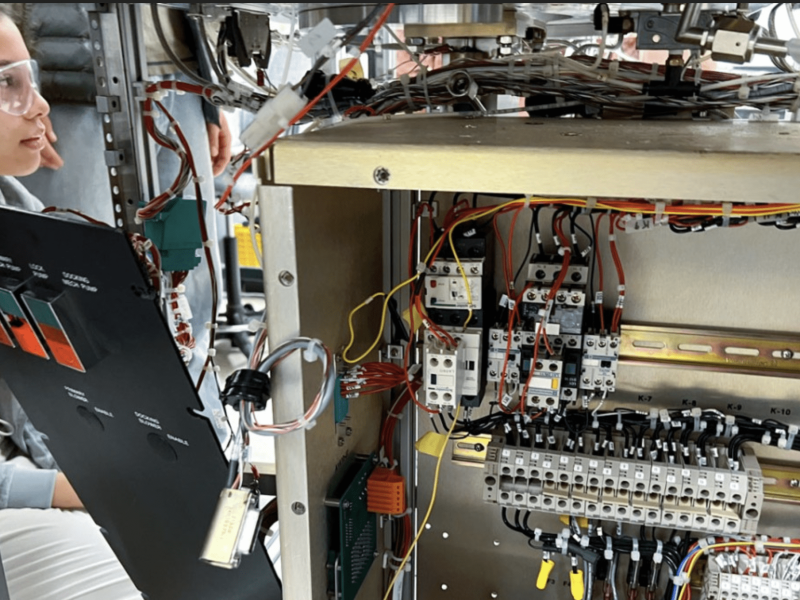 New Visions Engineering student Marley Thomson disassembles a plasma etcher.