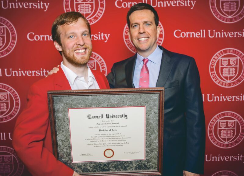 Corey Earle (left) with Ed Helms during the actor’s 2014 Convocation visit. Earle is holding Andy Bernard’s faux diploma from the set of “The Office.”