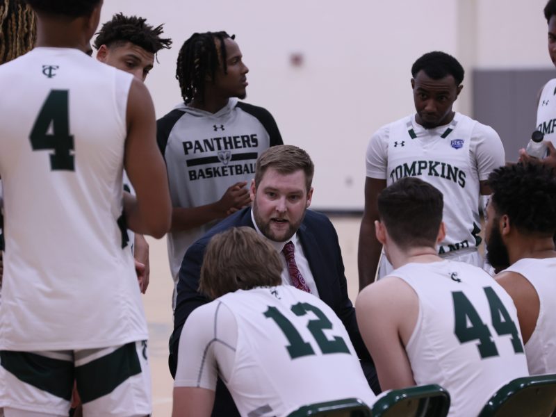 The TC3 Panthers and their coaches in a huddle