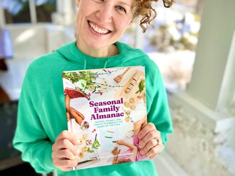 Emma Frisch holding the book she recently co-published