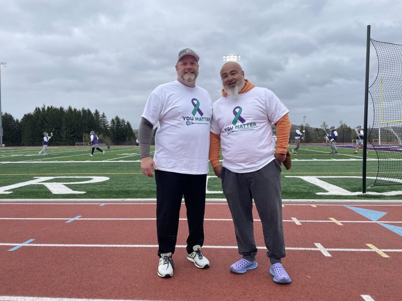 Dryden boys lacrosse assistant coach Don Davis (left) and volunteer coach Justin Williams (right) wear t-shirts made for the first annual "You Matter" game on April 18 to honor former assistant coach Matt Williams and spread mental health awareness.