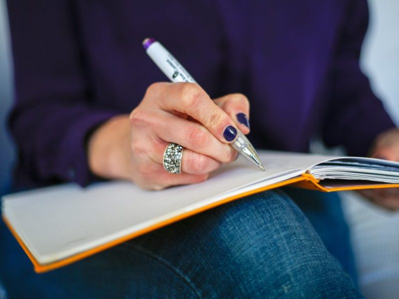 a person writing in a notebook
