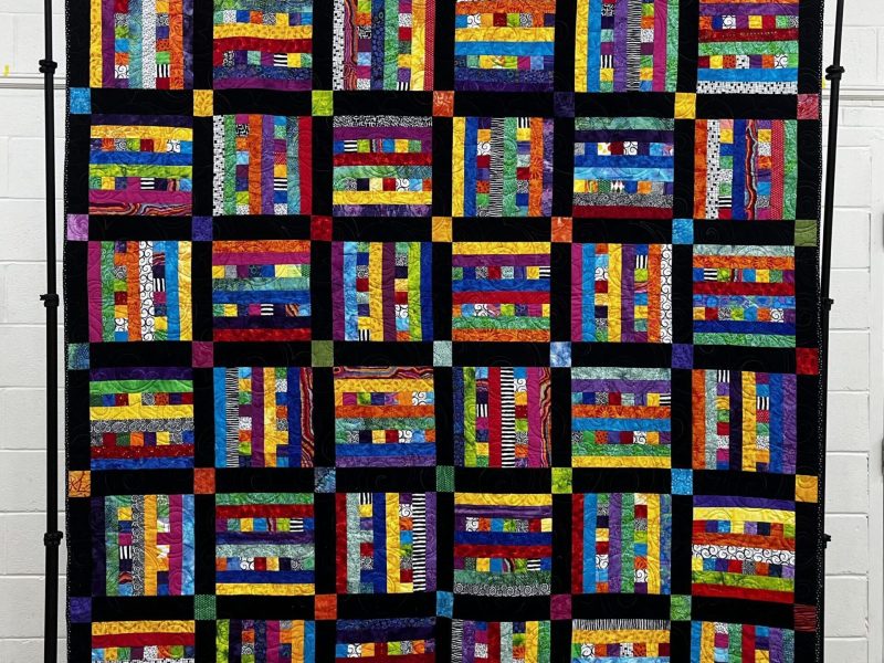 a multicolored block quilt