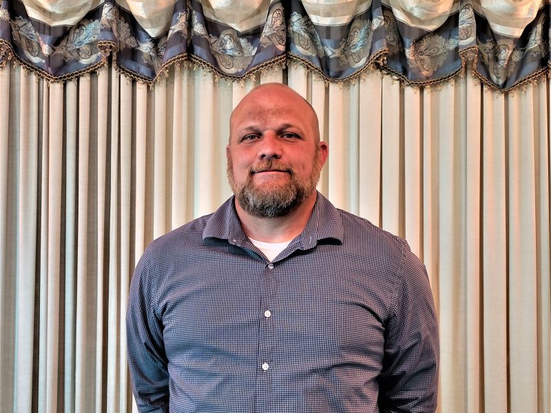 Man in front of curtains