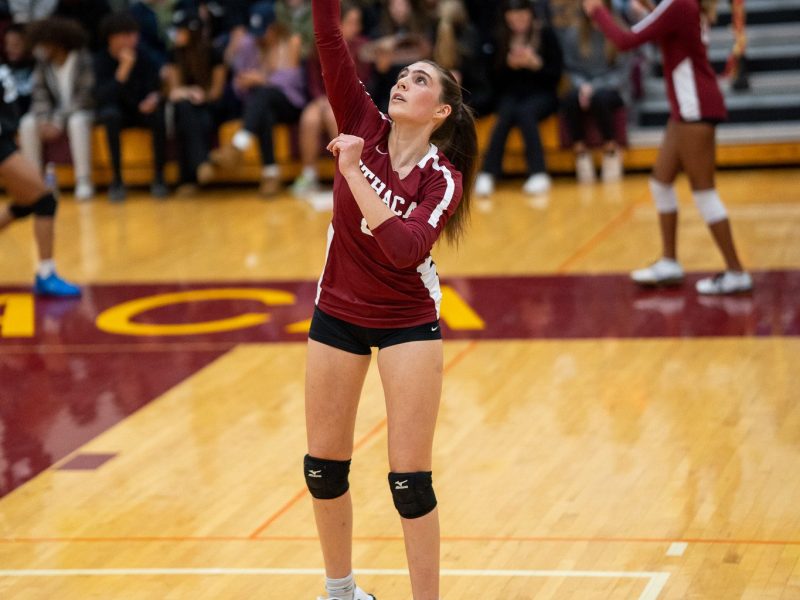 Ava hitting the volleyball during a match in the IHS gym