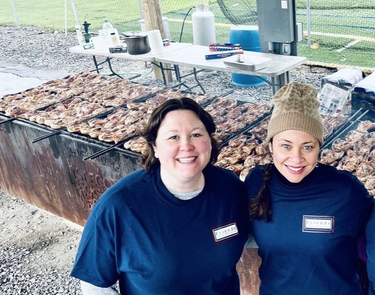 Chair of the Friends of the Lansing Community Library Megan Williams (left) and Amalia Gonzalez at the annual chicken bbq fundraiser.