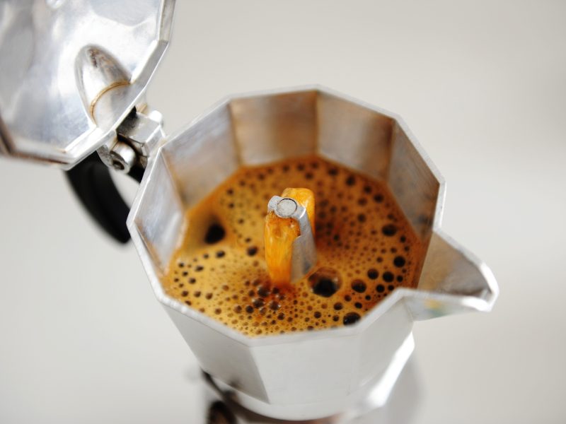 Coffee brewing in Italian espresso maker moka pot close up