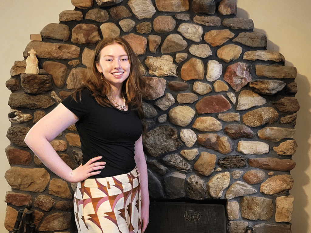 Photo by Linda Competillo
Olivia Arthur, valedictorian for Groton Jr/Sr High School's Class of 2025, stands by the fireplace in her home. Arthur has dreamed of being named for this honor since fourth grade and has worked hard to achieve it.
