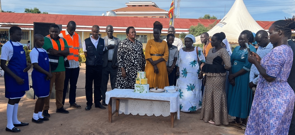 Photo provided
Students, teachers, staff, construction managers and city officials at a prayer and cake-cutting held on May 20 to celebrate the construction of a new solar-powered  kitchen at a Ugandan school. Solar Cooking Uganda