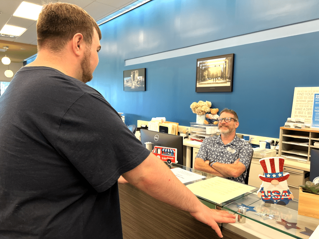 Photo by Jaime Cone Hughes
Student Tyler Smith of McGraw speaks with Bill Frances, Tompkins Cortland Community College enrollment services specialist, at the newly renovated Panther Welcome Center. TC3 Workforce Training
