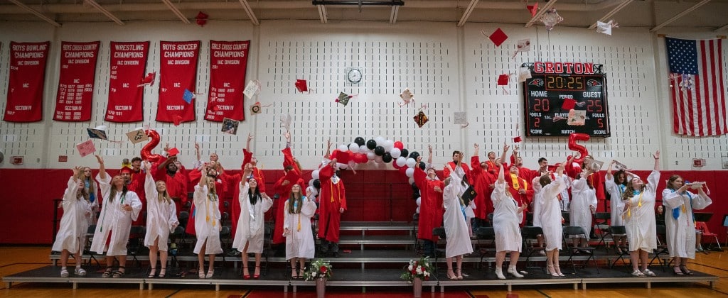 Photo by Linda Competillo 
Due to a rainy forecast, Groton High School's Class of 2025 was the first since 2020 to have its graduation ceremony held in the gym instead of Ross Field. Even the traditional "tossing of the caps", pictured here, took place indoors this year. Groton Class of 2025