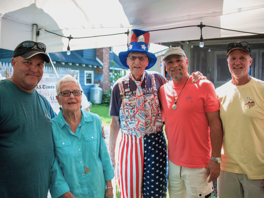 Photo by Joe Scaglione
The family and friends of Alice and Larry Thayer threw a party at the family’s cottage in Ithaca July 4 to celebrate the couple’s 70th wedding anniversary. In attendance was Abe Rivera who, as a child living in New York City, was hosted by the Thayers during the summer through the Fresh Air Fund. Left to right: Doug Thayer, Alice Thayer, Larry Thayer, Abe Rivera and Steve Thayer.  
