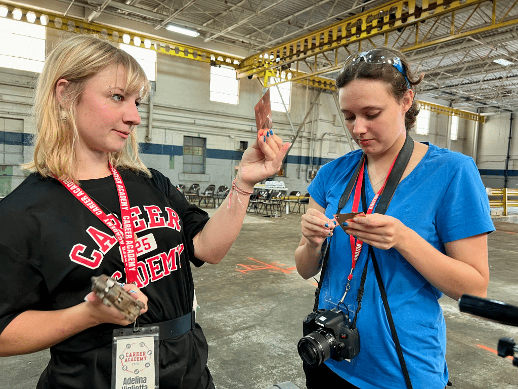 Photo by Jaime Cone Hughes
Adelina Biglietta (left), Groton High School student, makes engraved keychains out of sheet metal with Lena Brehm, an intern for the Groton Central School District Career Academy. 
