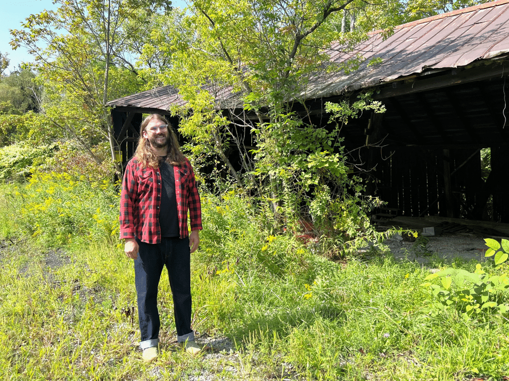 By Jaime Cone Hughes 
Zachary Larkins stands in front of the former Danby Highway Department shelter that he hopes to help the community transform into a covered skate park. 