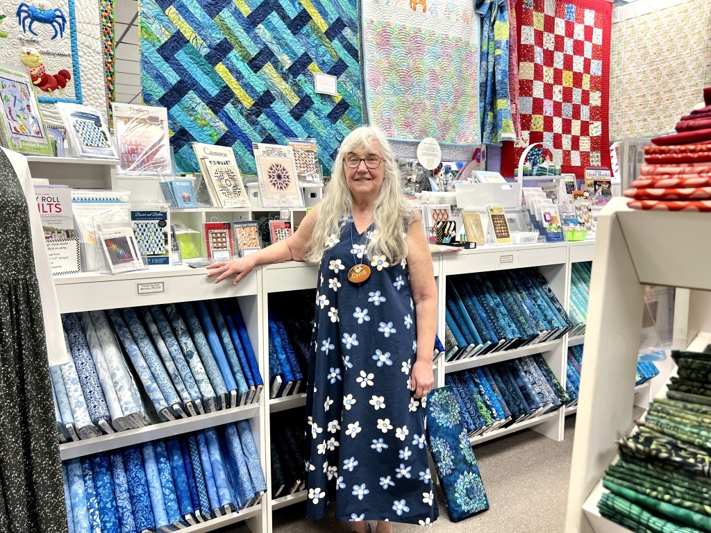 Photo by Jaime Cone Hughes
Cyndi Slothower, co-owner of Quilter’s Corner in Ithaca and member of the Tompkins County Quilters Guild, at her shop downtown. 