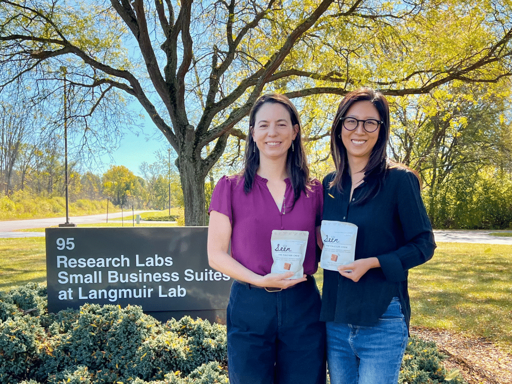 Photo by Jaime Cone Hughes 
Adrienne Bitar and Jennifer Han, founders of Seen Nutrition, hold their calcium chew product outside their new office space in Langmuir Labs in Ithaca. 
