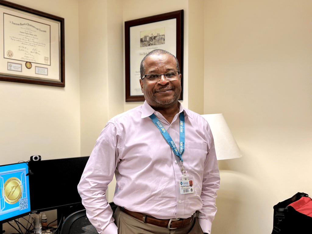Photo by Jaime Cone Hughes 
Dr. Auguste Duplan, head of adolescent psychiatry at Cayuga Medical Center, in his office in the Ithaca hospital’s Behavioral Health Unit. 