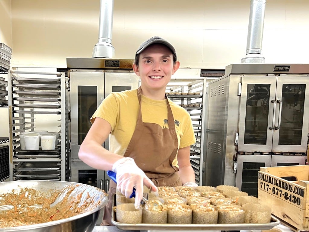 By Jaime Cone Hughes 
Emma Jorgensen, Gimme!’s lead baker, scoops morning glory muffins that will be served in the coffee company’s five local cafes. 