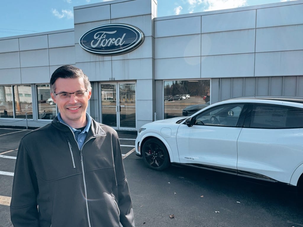 Photo provided
Jesse Dovi in front of the showroom of the 76 year old Ford Dealership started by his grandfather Tony Dovi as a Texaco gas station. Representing the third generation of Dovi's, Jesse has been working at the dealership part time since he was 14, and fulltime for the past 16 years.