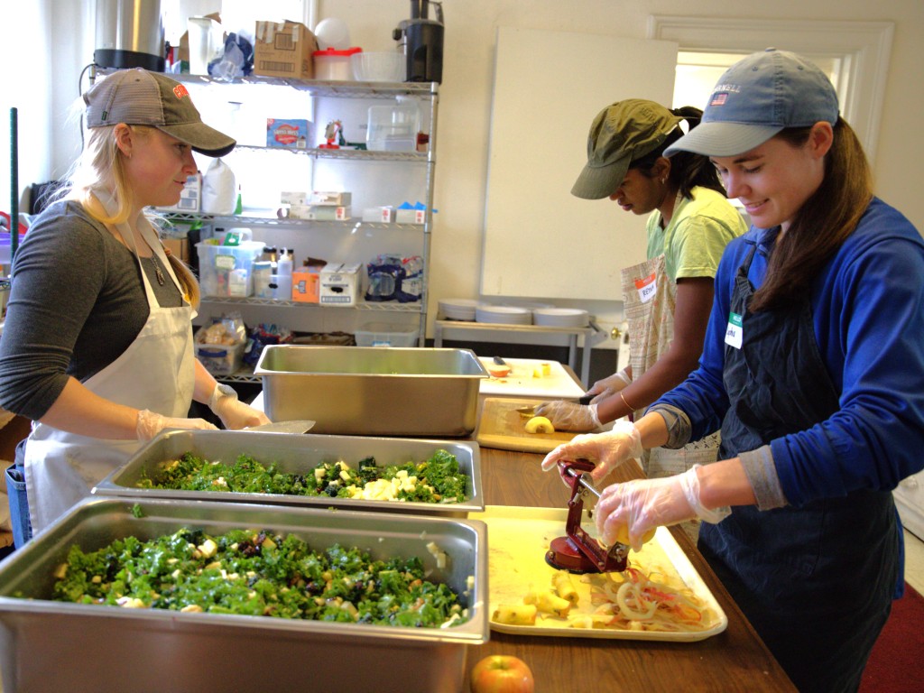 Photo by J.T. Stone
From left to right: Loaves and Fishes volunteers Anna Hardy, Retina Arun and Sophia Devling prepare food on Nov. 14.   
